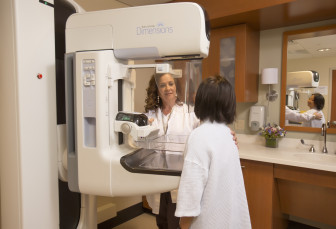 Mammography technologist Yolanda Jerez assists a patient undergoing 3D mammography at Stamford Hospital. 