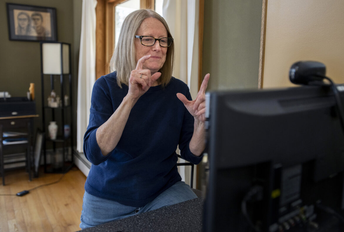 Doreen Simons, a certified deaf interpreter, uses a video remote interpreting (VRI) service from her Farmington home. 