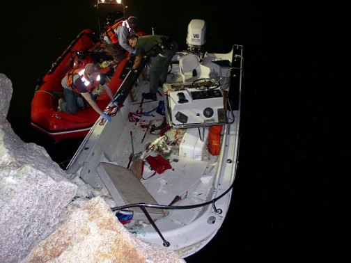 Investigators examine boat operated by Arthur K. Hall that crashed into a seawall, killing a passenger and injuring two others in 2009.