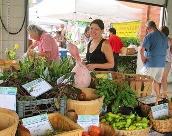 Shoppers buy fresh produce and other goodies at the Shelton farmers market.