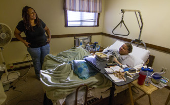 Debbie Hardy, home health care aide, with Frank Geraldino in his Seymour apartment. 