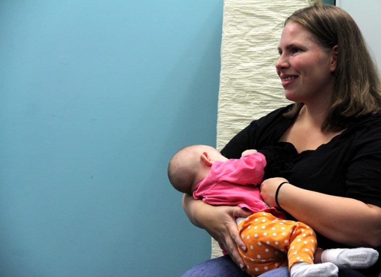 Amy Devoe breastfeeds Zoe, five months.