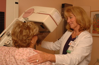 Donna Wirthman, breast imaging supervisor at the Hoffman Breast Health Center, assists a patient undergoing 3D mammography. 