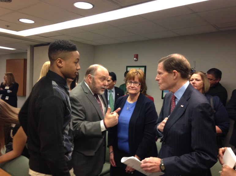 Among the participants speaking with Sen. Richard Blumenthal after the roundtable were Lance Supersad (at left), a young adult in recovery, and Karen Zaorski, whose son died of an overdose. 